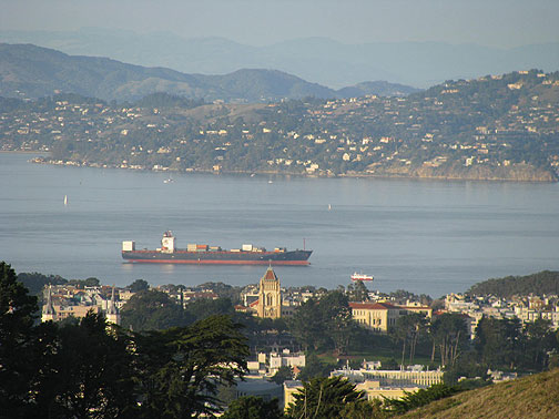 Close-up from Twin Peaks northward, partially filled container ship entering bay, Tiburon in background.
