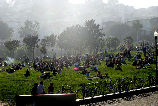 Winter light pours over Liberty Hill onto sunbathing denizens on the slopes above 19th Street in Dolores Park, Jan. 17, 2009.