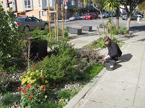 Jane Martin works the sidewalk extension at 23rd and Harrison.