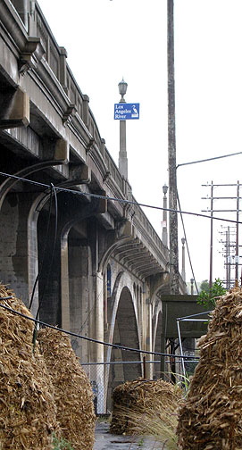 The historic Pasadena Viaduct soars over the FarmLab and the Los Angeles River.