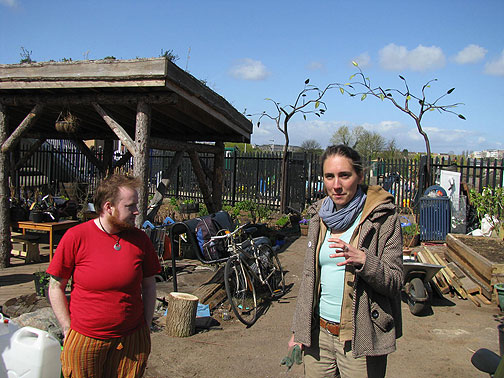 Jenny and one of the volunteers, sculpture gate and living roof on shelter behind.