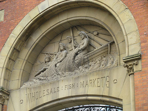 Old fish market facade, now enclosing a new office building.