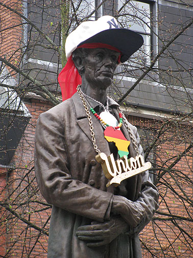 Honest Abe as Homeboy? A weird art project commissioned by local authorities. The statue actually commemorates Lincoln's thanks to the textile workers of Manchester, for supporting the Union during the Civil War (and the effort to abolish slavery) even though it made life in England for working people much harder, since there was dire shortages of raw cotton due to the embargo against the South.