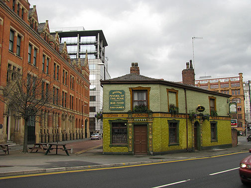 The historic pub is a favorite of Manchester United hooligans... surrounded by new development and redeveloped old buildings.