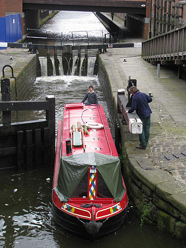 Local canal boat makes its way through a lock.