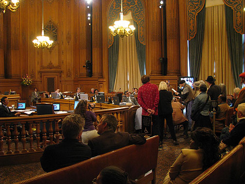 John Ross at podium addressing San Francisco Board of Supervisors, refusing his "day".