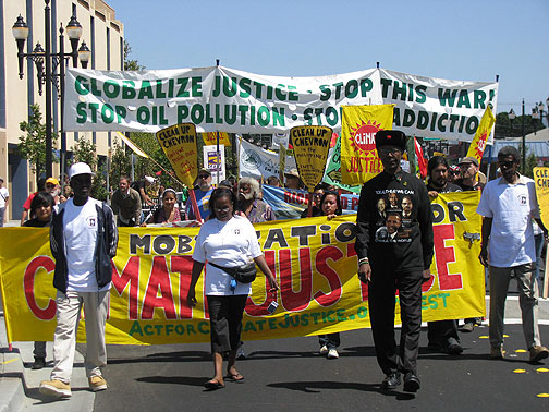 The march starts, led by Henry Clark of the West County Toxics Coalition (in the black hat).