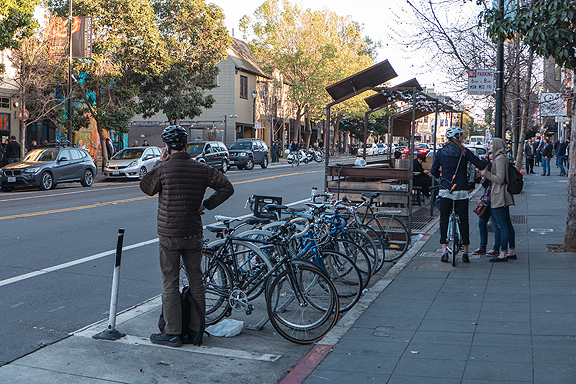 This parklet on Valencia in San Francisco features ample bike parking and cozy wooden benches.