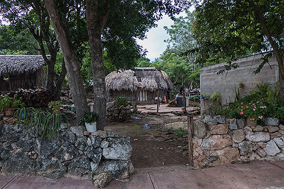 A neighbor's property with several traditional huts.